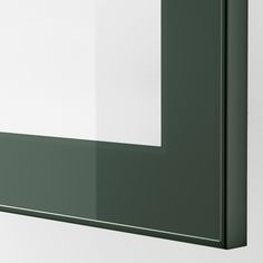 a white and green wall mounted mirror