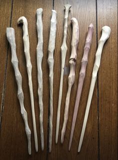 five different types of toothbrushes on a wooden floor with one missing the end