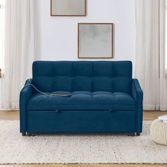 a blue couch sitting on top of a white rug