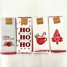 four tea towels with christmas designs on them are lined up in a row, one has a hot chocolate bar and the other has a candy cane