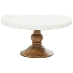 a white marble top table with wooden legs and an oval base on a white background