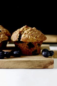 some blueberry muffins are on a cutting board