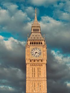 the big ben clock tower towering over the city of london on a partly cloudy day