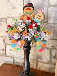 a vase filled with lots of colorful flowers and teddy bears on top of a wooden table