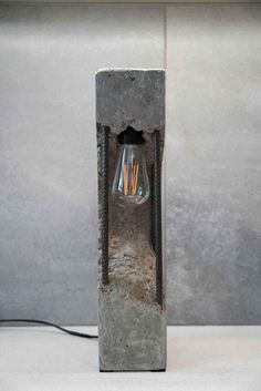 a light that is on top of a cement block with a wire attached to it