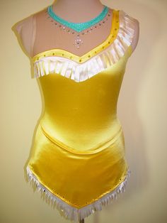 a mannequin wearing a yellow dress with white ruffles