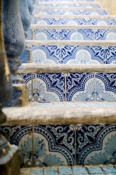 some blue and white tiles on the steps