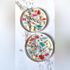 Two (2) Clear Resin Coasters With The Word "Chill" Or "" Featured In Gold Foiled Letters. The Coaster Is Filled With Colorful Assorted Pills And Gold Leafing. Colorful, Vibrant Pills Are Nestled Within Clear Epoxy Resin That Is Both Durable And Chic. The Text In Gold Foil Is Placed Inside The Resin For Optimal Use And Durability. The Colorful Pills Make Them An Ideal Gift For A Doctor, Nurse, Or Pharmacist In Your Life. These Pill Coasters Would Also Make A Perfect Hostess Or Housewarming Gift F Photo Resin Coasters, Pill Coasters, Resin Art Coasters, Epoxy Coasters, Clay Inspo, Gold Leafing, Perfect Hostess, Cool Coasters, Pottery Platter