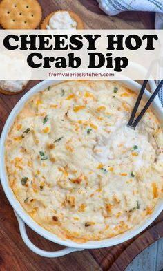 cheesy hot crab dip in a white dish with crackers on the side