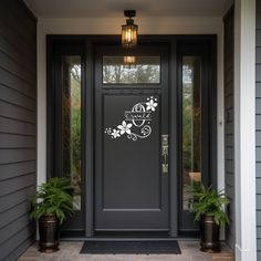 the front door is decorated with white flowers and monogrammed letters on it's side