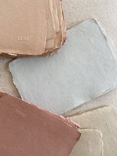 four different colors of paper laying on top of each other with the words clay written on them