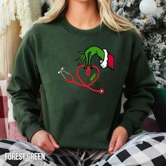 "Nurse Christmas Sweatshirt, Nurse Sweatshirt Christmas, Nurse Christmas Shirt, Christmas Sweatshirt, Grinch Stethoscope, Doctor Christmas HOW TO ORDER SHIRT 1-) Please, Check and Review all Photos. 2-) Select Your  Size. 3-) Click ADD TO CART and You can go back to add more product color and text color or You can complete the checkout process. 4-)Please Click \"Proceed to Check Out\" 5-) Finally, Your Custom Shirt will be ready to ship 2-5 Business Day. SIZING Please reference our sizing chart in the photos to ensure correct size selection. Size down on this one for a standard fit. -Colors may vary from monitor to monitor. Please keep that in mind as you are selecting colors since colors can vary slightly from the screen color to the printed product. Shipping: We work hard to ship orders Grinch Sweatshirt Ideas, Graduate Nursing School, Nurse Style, Elsa Shirt, Nurse Sweatshirt, Screen Color