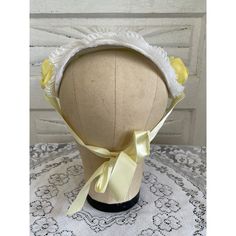 Vintage 1950s headband/bonnet hat featuring yellow flowers and satin ties. Perfect for adding a touch of retro elegance to any outfit. The hat measures end to end 10" and from top to bottom 4.5". The hat is in great condition it is clean with no issues.  * Authentic vintage from the 1950s * Beautiful yellow floral design * Satin ties for adjustable fit * Perfect for special occasions or daily wear Condition: Pre-Owned Good Vintage Adjustable Headpiece For Garden Party, Retro Adjustable Costume Hats And Headpieces For Church, Yellow Adjustable Costume Hats For Kentucky Derby, Adjustable Yellow Headpiece For Church, Adjustable Yellow Hats For Kentucky Derby, Yellow Adjustable Headpiece For Church, Adjustable Yellow Headpiece For Kentucky Derby, Vintage Summer Headband, Adjustable Yellow Headband Costume Hat