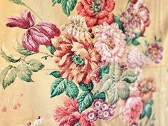 a close up of a flowered fabric with leaves and flowers on the back side