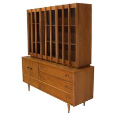 a large wooden cabinet with drawers and doors