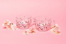 three glass cups with pink flowers on them