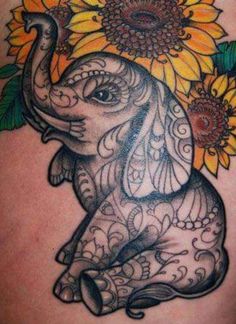 an elephant with sunflowers on its head is shown in this tattoo design photo