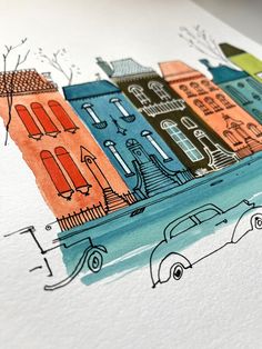 a drawing of some buildings and cars on the street in front of watercolor paper