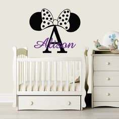 a wall decal with the name and two minnie mouse ears