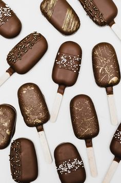 chocolate covered marshmallows are arranged on top of each other with gold foiling