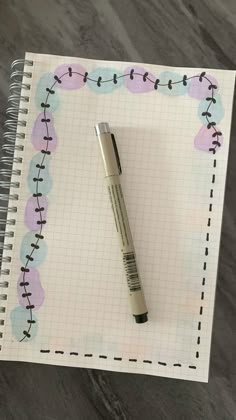 a notepad with a pen on top of it