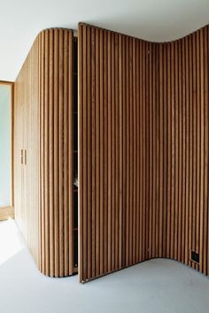 a room divider made out of wooden slats