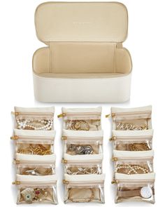 the inside of a white case filled with jewelry