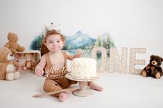 a baby sitting on the floor with a cake