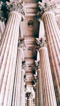 the columns are all lined up and there is a clock on top