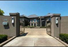 an entrance to a large house with lots of windows