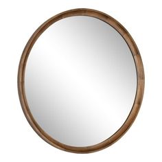 a round mirror on a white wall with a wooden frame and wood trimmings