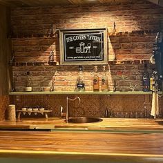 a wooden counter top in a kitchen under a sign that says free cavern tavern on it