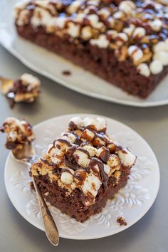 there is a piece of chocolate cake with marshmallows on it and a fork