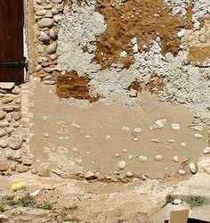 an old stone building with a wooden door