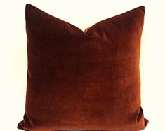 a brown pillow sitting on top of a white table