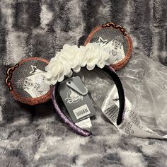 two headbands with flowers on them sitting on top of a fur covered surface