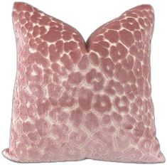 a pink and white pillow with an animal print pattern on the front, sitting on a white background