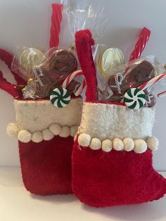 two red christmas stockings filled with candy and candies