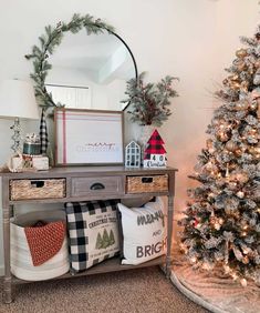 a christmas tree and other decorations in a living room with a mirror on the wall