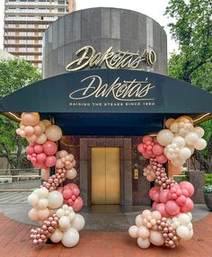 an entrance to a restaurant decorated with balloons