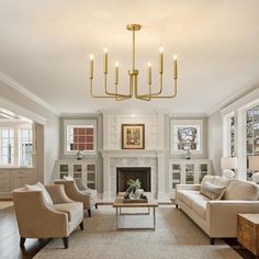 a living room with couches, chairs and a fire place in the middle of it