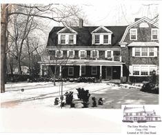 an old black and white photo of a house in the winter with snow on the ground