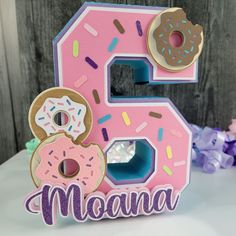 the number five is decorated with donuts and sprinkles