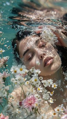 a woman swimming in the water surrounded by daisies and other wildflowers with her eyes closed