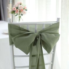 a chair with a green bow on it