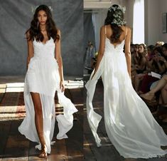 two models walk down the runway in white dresses