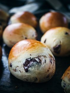 rolls with chocolate filling sitting on a baking sheet