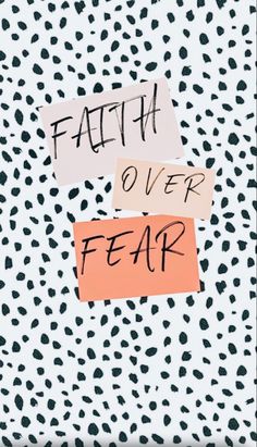 two pieces of paper that say faith over fear on top of a leopard print background