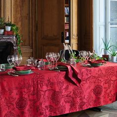 the table is set with wine glasses and plates