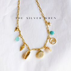 Beach Multi Charm Necklace Crafted with the essence of sun-kissed sands and the whispers of ocean waves, this exquisite charm necklace captures the allure of coastal beauty. Whether worn as a statement piece for a sunset stroll along the shoreline or as a subtle nod to the beauty of the sea everyday, this necklace is a must have! •Gold plated mother of pear charms •Natural cowrie shell, aqua chalcedony, moonstone and turquoise charms. •24kt gold plated -lead, nickel & cadmium free•Heavy plating, tarnish resistant, water friendly The Whispers, Turquoise Charm, Blue Charm, Bead Ideas, Gem Necklace, Necklace Craft, Aqua Chalcedony, Cowrie Shell, 24kt Gold